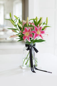 pink lilies in a glass vase